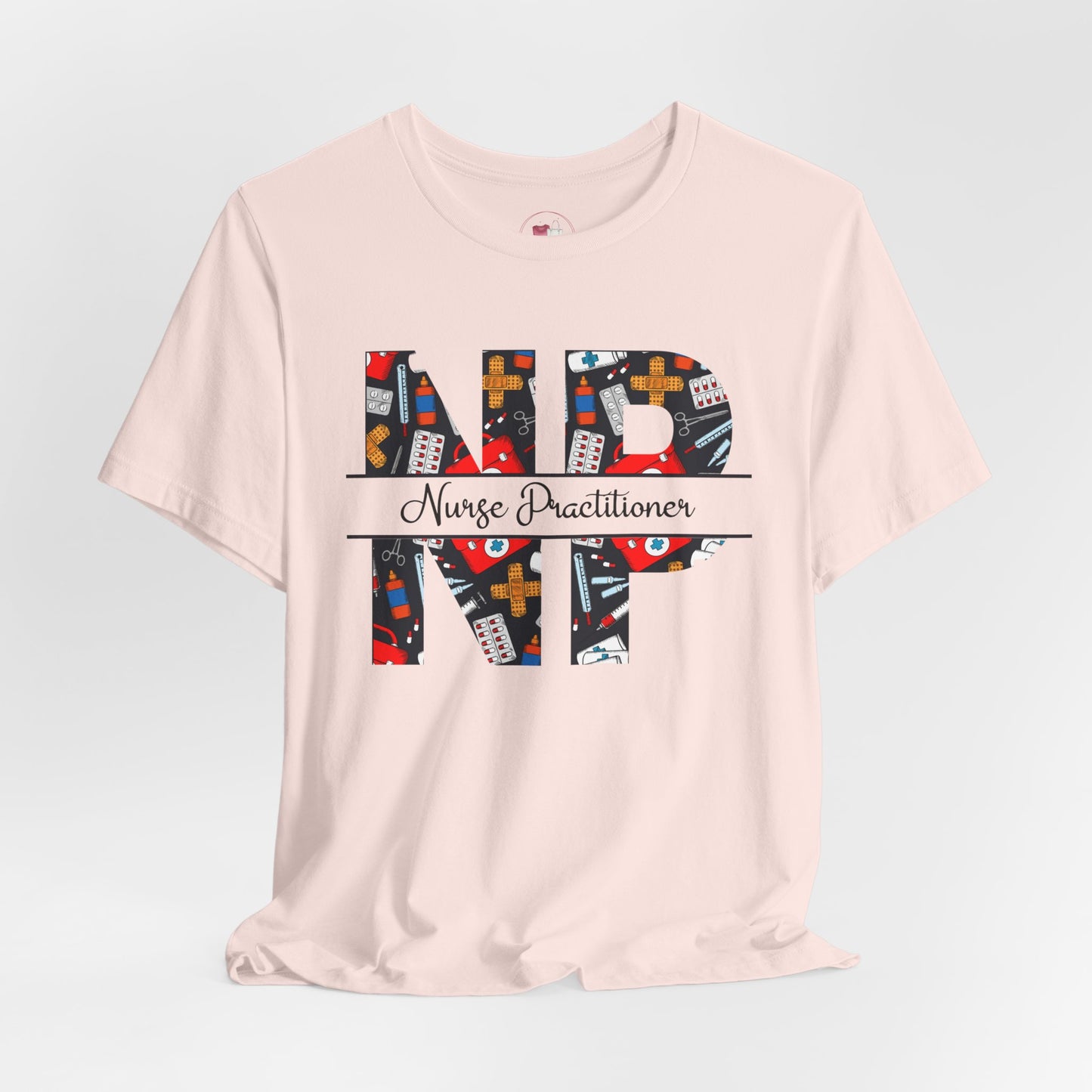 Pink t-shirt with colorful 'NP' Nurse Practitioner' design on a light gray background
