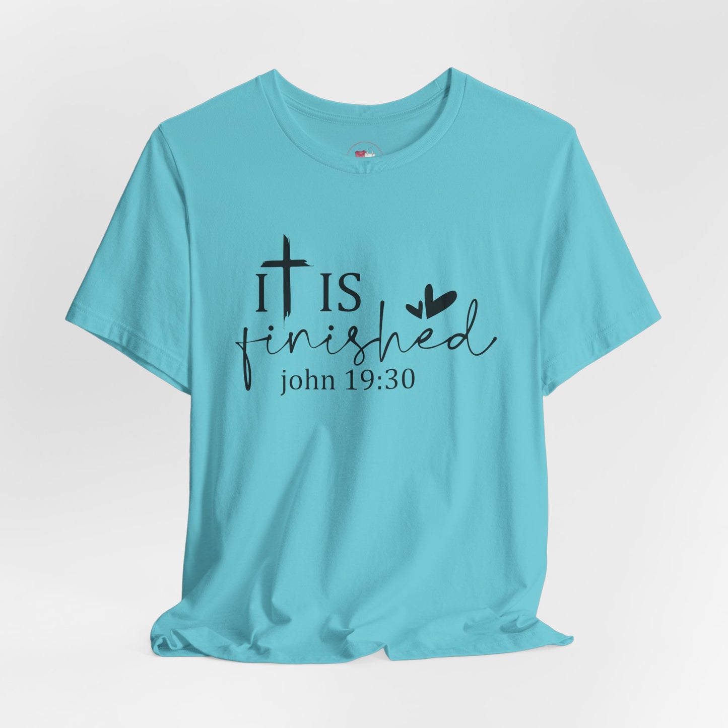Light blue t-shirt with 'It is finished' text and cross design on a white background, Bible scripture