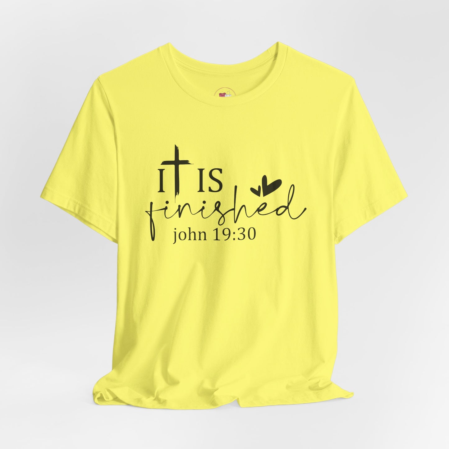 Yellow t-shirt with 'It is finished' text and cross design on a white background, Bible scripture