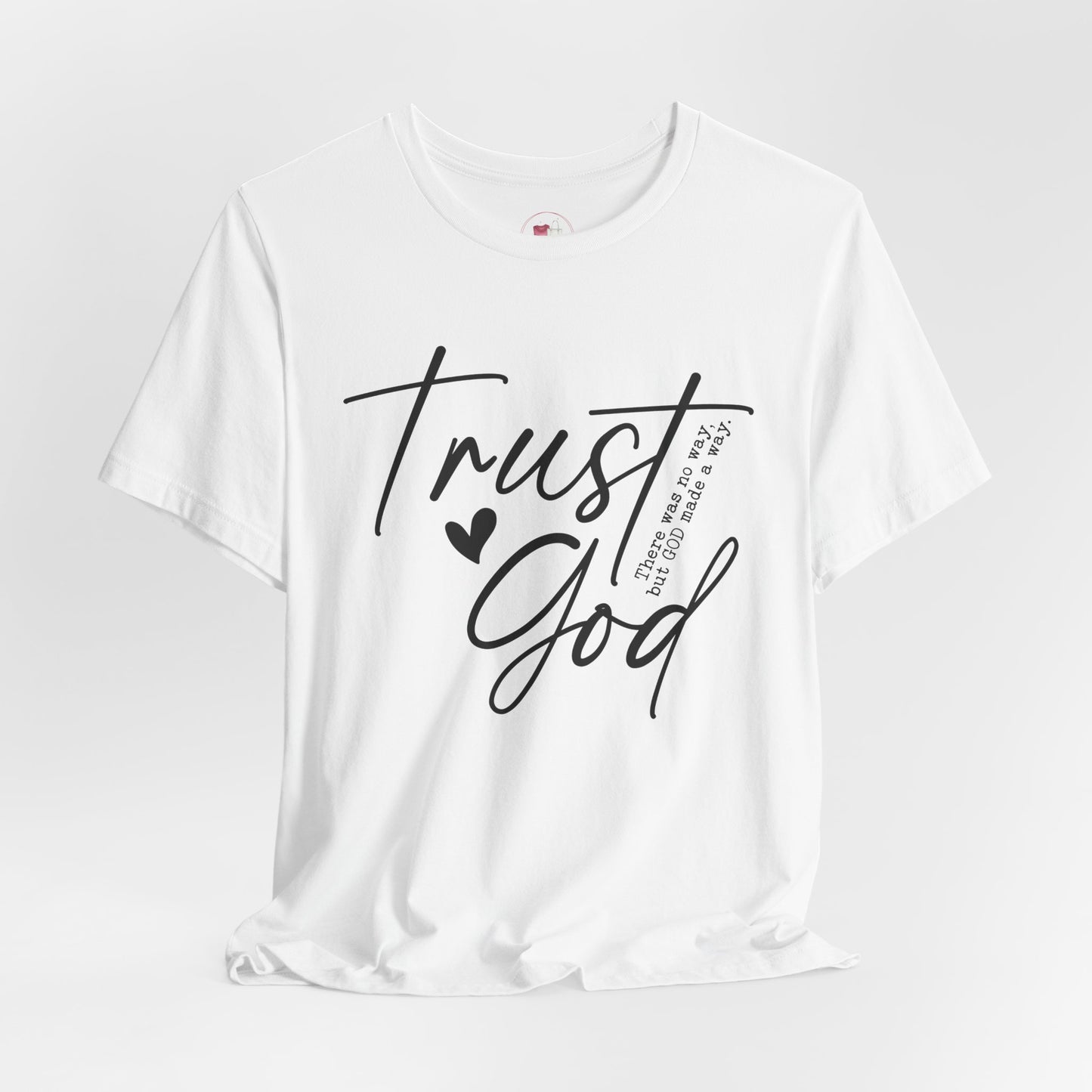 White t-shirt with 'Trust God' text on a light gray background