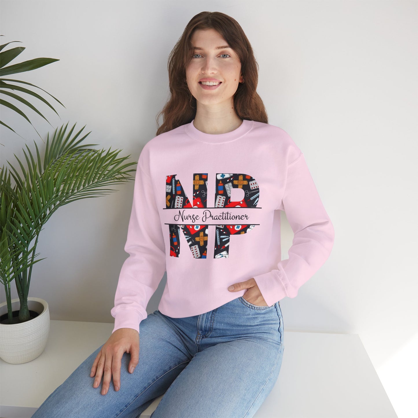Pink sweatshirt with 'NP' Nurse Practitioner' design.