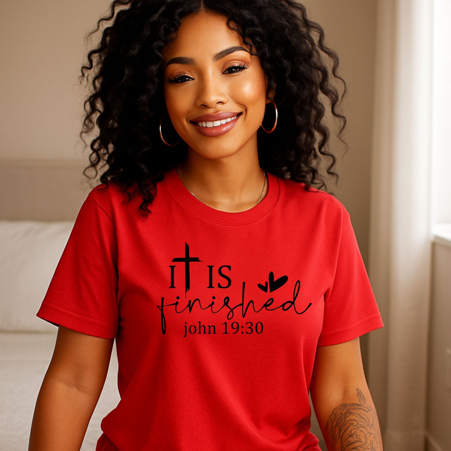Red t-shirt with 'It is finished' text and cross design on a white background, religious shirt