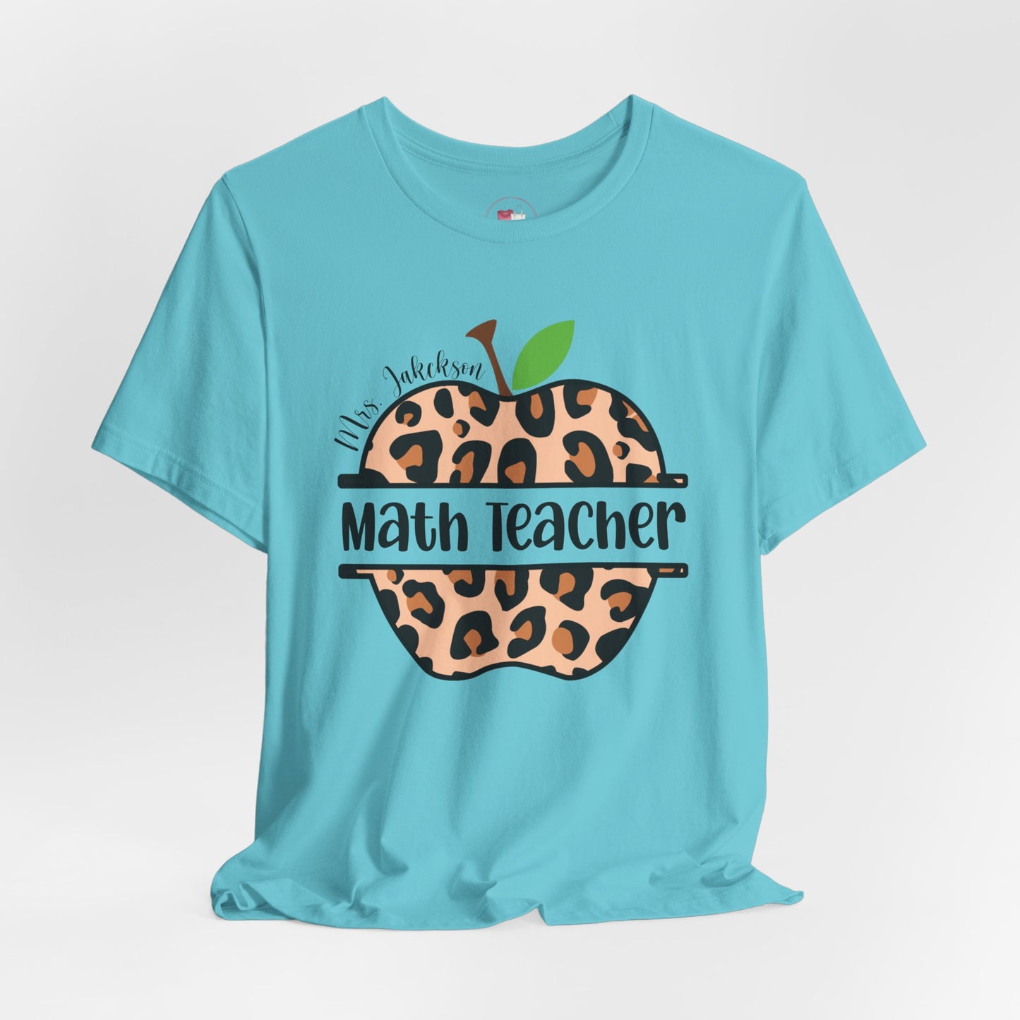 Light blue t-shirt with leopard print apple graphic and text on a white background