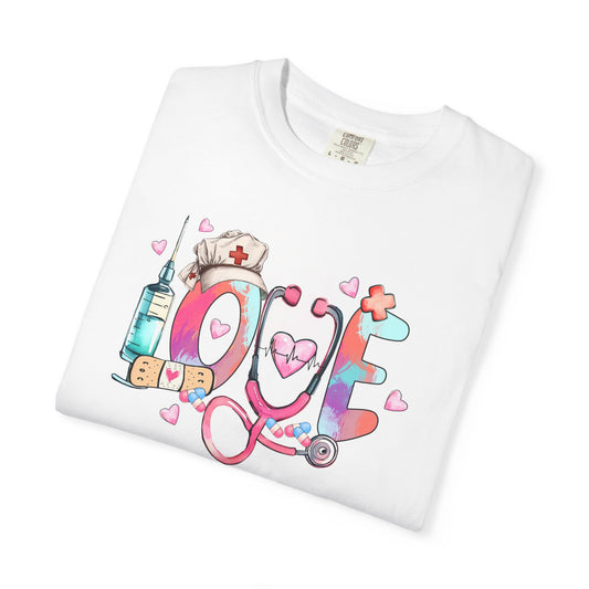 White t-shirt with colorful 'LOVE' design featuring a stethoscope, syringe, and nurse's hat on a white background.