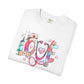 White t-shirt with colorful 'LOVE' design featuring a stethoscope, syringe, and nurse's hat on a white background.