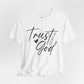White t-shirt with 'Trust God' text on a light gray background