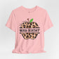 Pink t-shirt with leopard print apple design and text on a light gray background