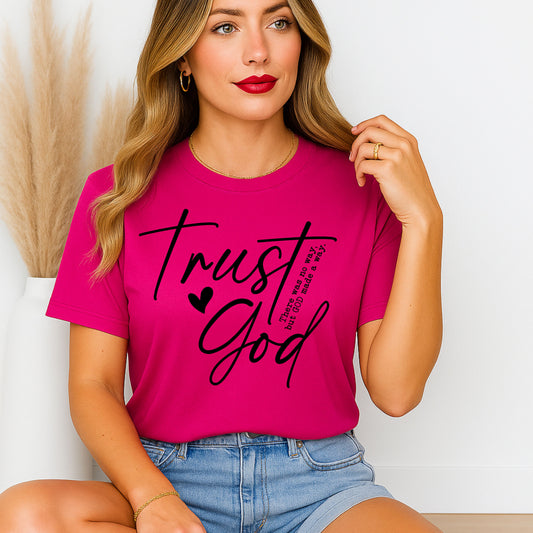 Woman wearing a pink t-shirt with 'Trust God' text