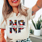Cream t-shirt with colorful 'NP' Nurse Practitioner' design on a light gray background