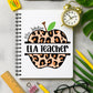 Notebook with leopard print apple design labeled 'ELA Teacher' on a desk with stationery items.