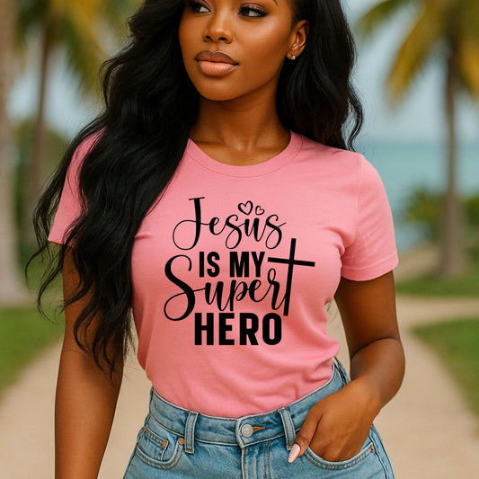 Christian based pink t-shirt with 'Jesus is my super hero' text outdoors.
